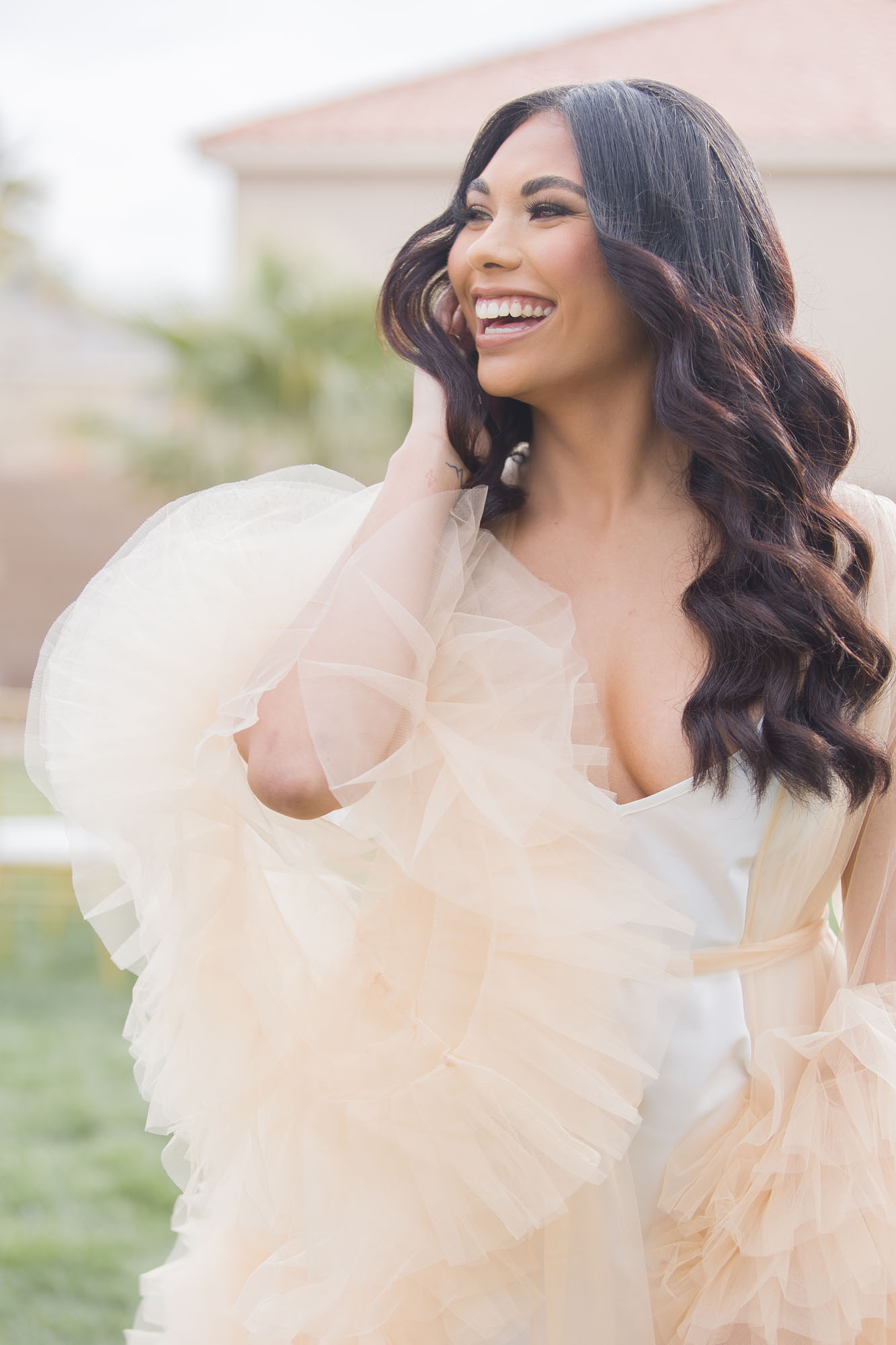 A happy bride smiles while walking through the lawn of one of the mansion wedding venues las vegas