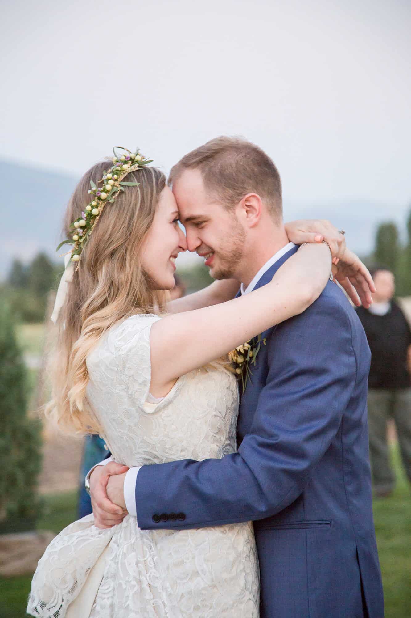 NEwlyweds touch foreheads while hugging at their outdoor wedding venues las vegas