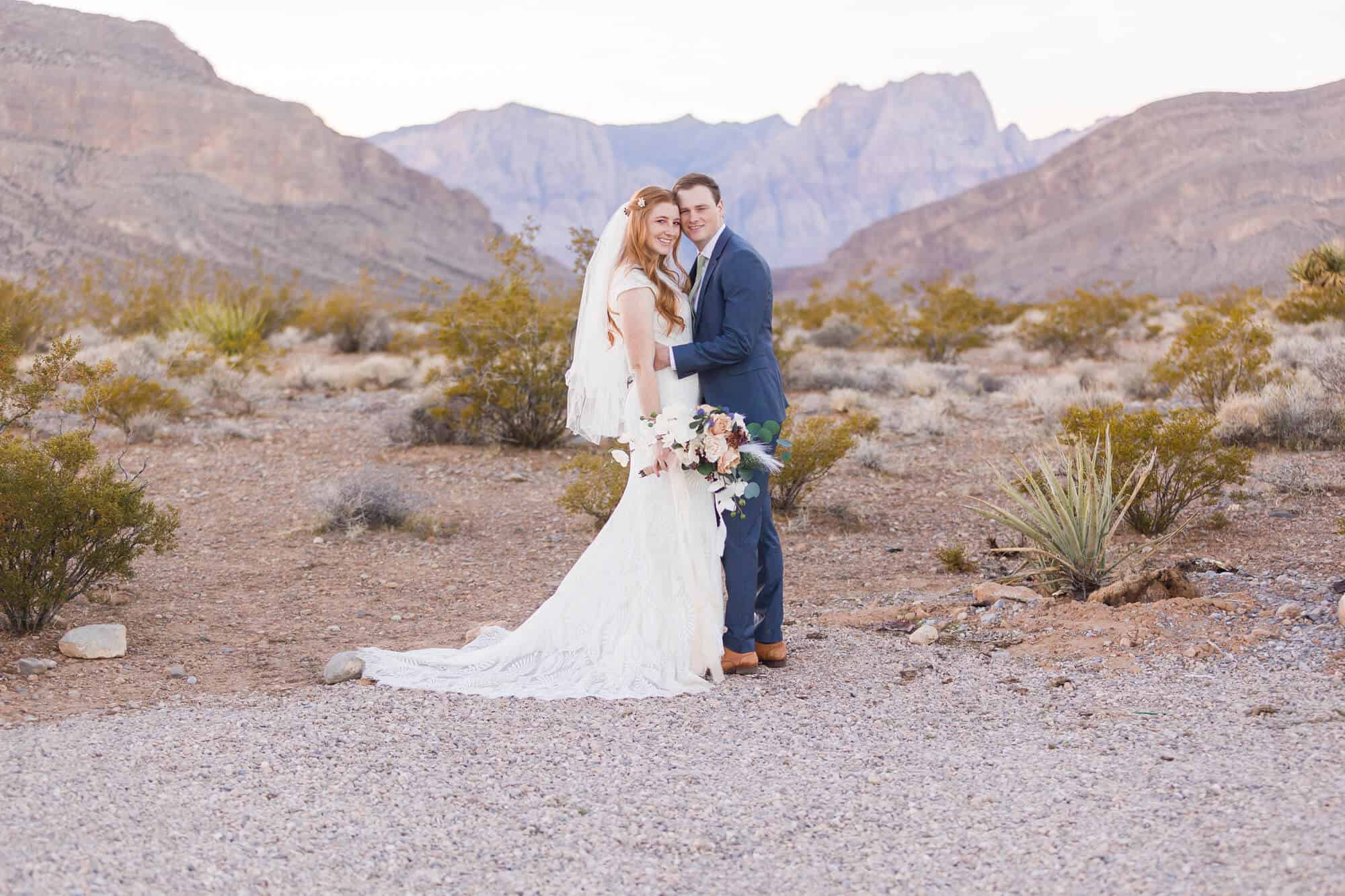 Bride and Groom stand facing each other and smiling in the Desert Ceremony Space at Cactus Joes in Las Vegas.